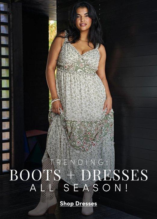 Model wearing a sleeveless floral maxi dress with a mixed print border, styled with white ankle boots. Text reads, “Trending: Boot + Dress All Season!” with a “Shop Dresses” call to action.