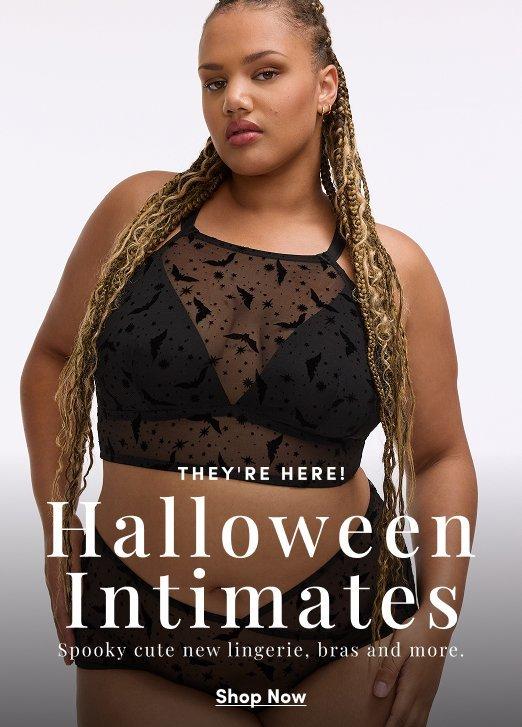 Model wearing a black Halloween-inspired mesh bralette with star and moon details and matching panties against a light neutral background. Text reads, “They’re Here! Halloween Intimates. Spooky cute new lingerie, bras and more.” with a “Shop Now” call to action.