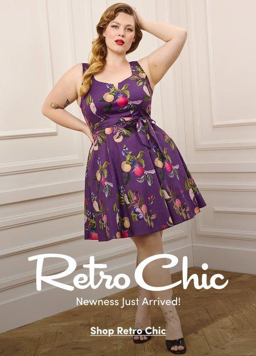 Model wearing a sleeveless purple fit-and-flare dress with a colorful fruit print and a matching waist tie, paired with black heeled sandals. Text reads, “Retro Chic. Newness Just Arrived!” with a “Shop Retro Chic” call to action.