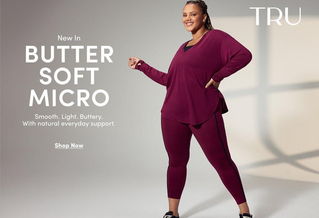 Model wearing a burgundy long-sleeve performance top with matching leggings and black athletic shoes. Text reads, “New In Butter Soft Micro. Smooth. Light. Buttery. With natural everyday support.” with a “Shop Now” call to action.