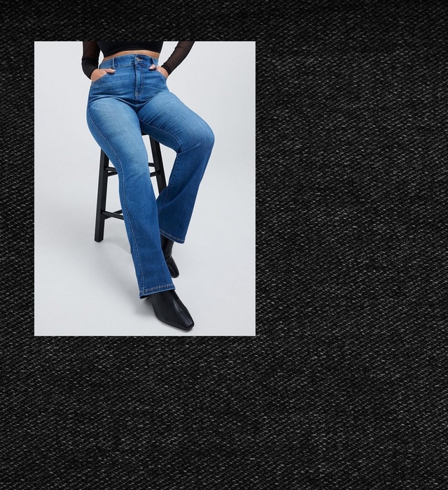 Cropped photo of a woman's lower body seated on a black stool with crossed legs, framed within a rectangular inset against a dark textured charcoal denim-like background. She wears a black long sleeve mesh top cropped above the waist, with both hands tucked into the front pockets of medium wash bootcut jeans featuring a high rise waistband, paired with black pointed toe ankle boots.
