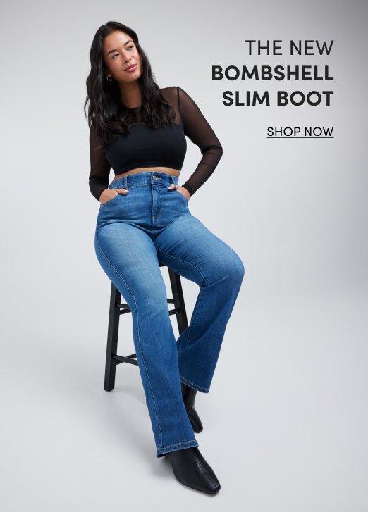 Model seated on a black stool wearing a black long-sleeve mesh top, blue Bombshell Slim Boot jeans, and black ankle boots against a light gray background. Text reads, “The New Bombshell Slim Boot.” with a “Shop Now” call to action.