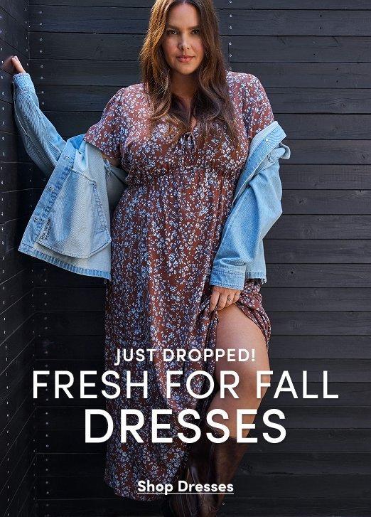 "Banner ad for fall dresses collection featuring a woman with long brown hair standing against a dark wood-paneled wall, wearing a brown floral maxi dress with a leg slit, a light denim jacket draped off her shoulders, and brown boots. Text reads: Just Dropped! Fresh For Fall Dresses, Shop Dresses."