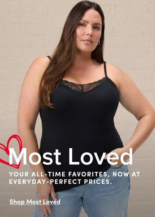 Banner ad for the Most Loved collection. A woman with long brown hair stands against a beige brick background, wearing a black lace-trim cami and light wash jeans. Text reads: Most Loved, Your All-Time Favorites, Now At Everyday-Perfect Prices, Shop Most Loved.