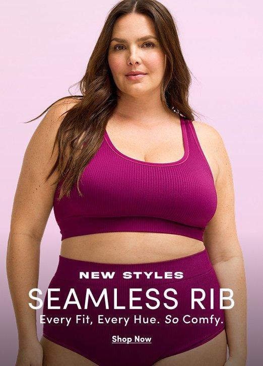 Banner ad for the Seamless Rib collection. A woman with long brown hair stands against a light pink background, wearing a magenta ribbed bralette and matching high-waisted bottoms. Text reads: New Styles, Seamless Rib, Every Fit, Every Hue, So Comfy, Shop Now.