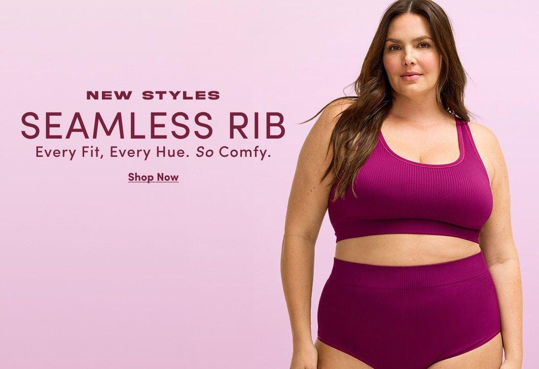 Banner ad for the Seamless Rib collection. A woman with long brown hair stands against a light pink background, wearing a magenta ribbed racerback bralette and matching high-waisted bottoms. Text reads: New Styles, Seamless Rib, Every Fit, Every Hue, So Comfy, Shop Now