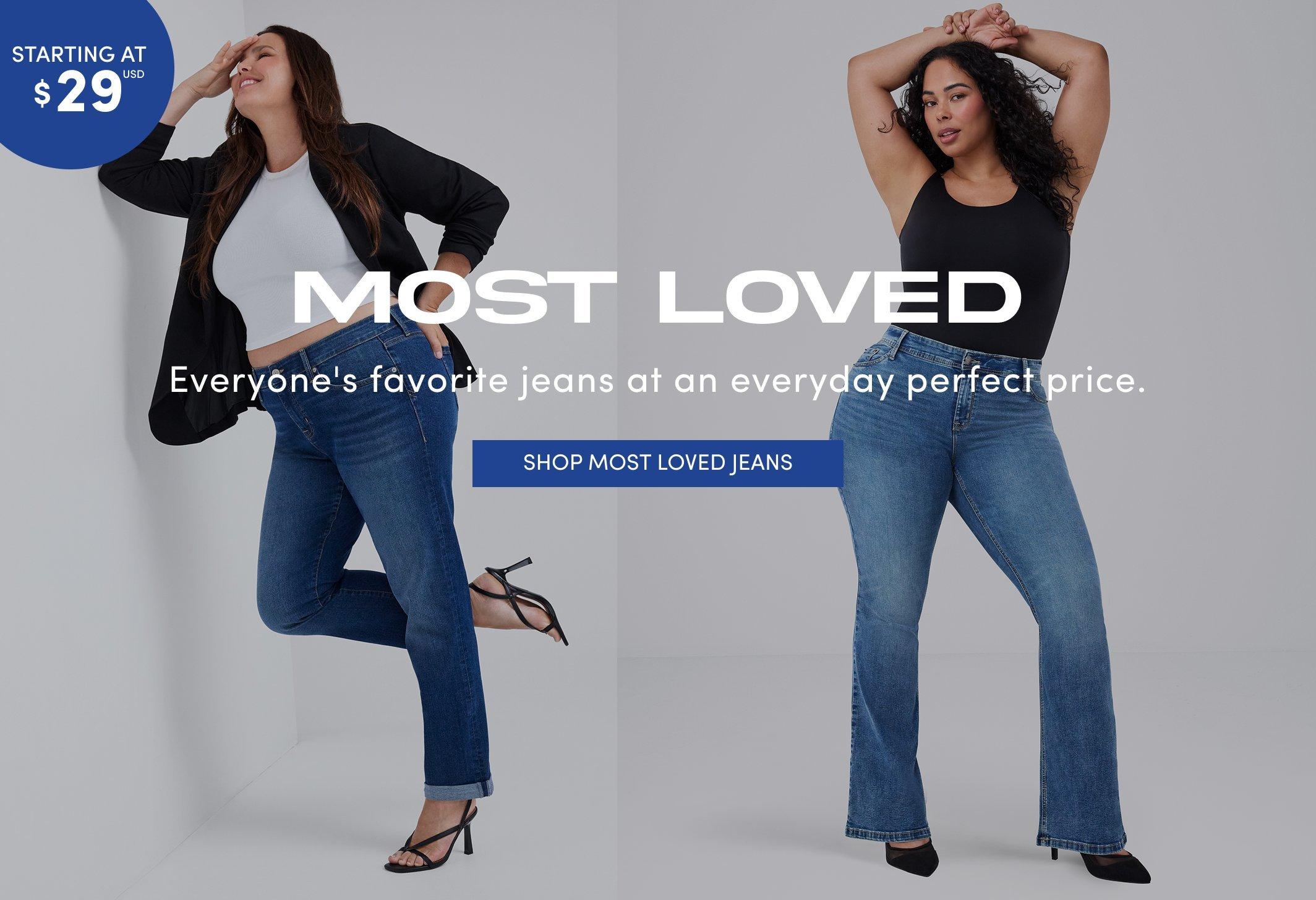 "Banner ad for the Most Loved jeans collection, showing two women against a light gray background. One with long brown hair wears a white crop top, black blazer, cuffed straight jeans, and black heels; the other with curly dark hair wears a black tank top, bootcut jeans, and black heels. Text reads: Starting At $29 USD, Most Loved, Everyone's favorite jeans at an everyday perfect price, Shop Most Loved Jeans."