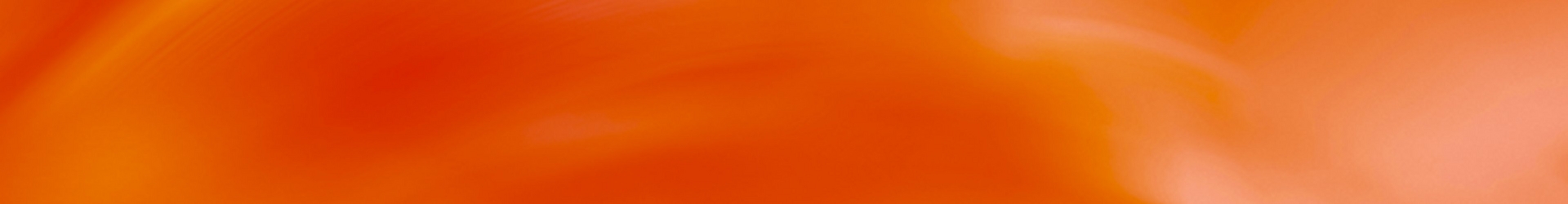 Abstract wide banner image of an orange and red gradient background with soft swirling light patterns, transitioning to a lighter peachy orange on the right side. No people, text, or objects are present in the image.
