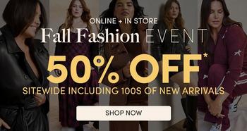 Background photo of three women wearing dark colored coats and jackets against a dark background, with white text overlaid. At the top, small white text reads 'ONLINE + IN STORE'. Below it, elegant serif text reads 'Fall Fashion' followed by bold white text reading 'EVENT'. Underneath, very large bold white text reads '50% OFF' with an asterisk, followed by smaller text reading 'SITEWIDE INCLUDING 100s OF NEW ARRIVALS'. At the bottom, a white outlined button contains white text reading 'SHOP NOW'.