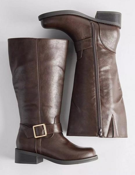 A pair of dark brown knee-high boots arranged on a plain white background, one standing upright and the other lying on its side to show the inner face. The upright boot has a smooth faux leather shaft with a center seam, a wide buckled strap with a gold-tone square buckle at the ankle, a rounded toe, and a low stacked block heel. The boot on its side shows a full-length zipper running up the inner shaft with a metal pull, a small slit at the top edge, and a stitched tab at the calf.