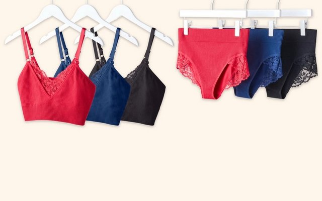 Red, navy, and black seamless bras and panties displayed on hangers.